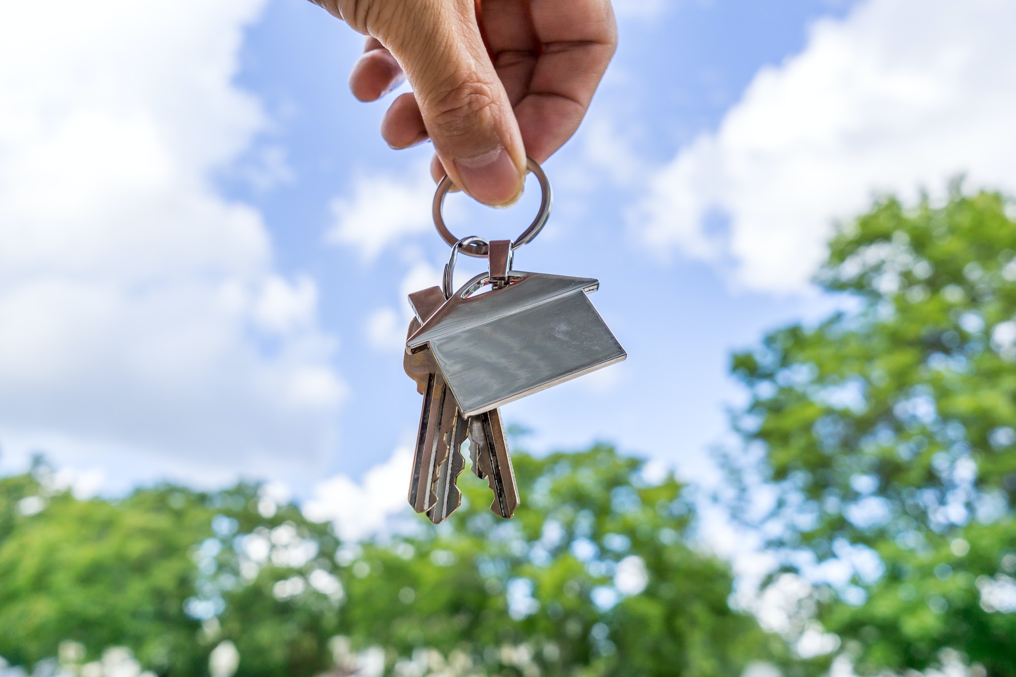 Real estate agent holding a house shape keychain